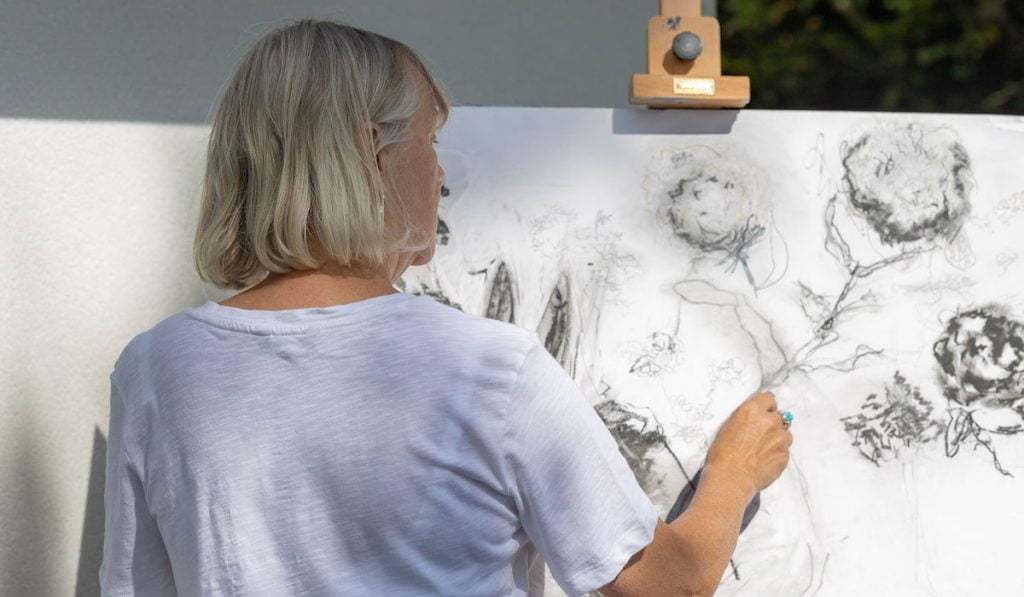 Caroline Rose drawing flower with charcoal